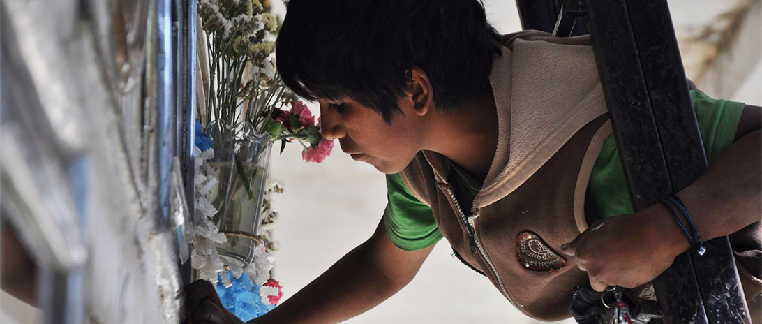 picture of Jose cleaning a gravestone