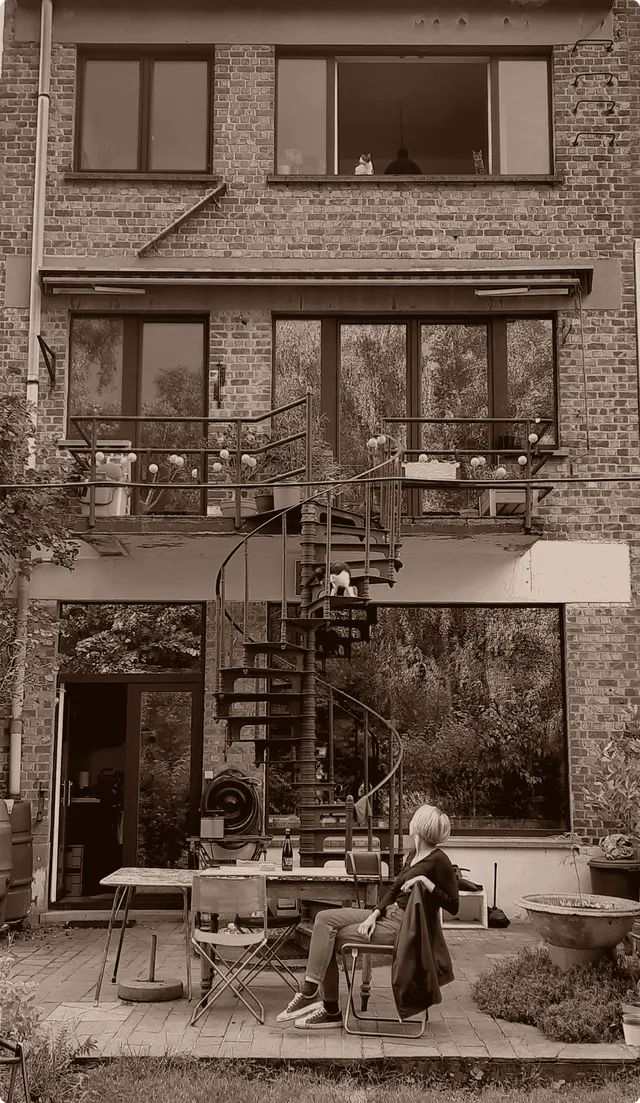 Flora seated in the garden of her brick townhouse